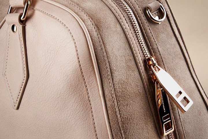 A close up look at the high quality leather, suede and gold hardware